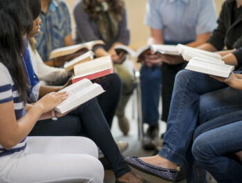 Diverse group of teens studying the Bible.